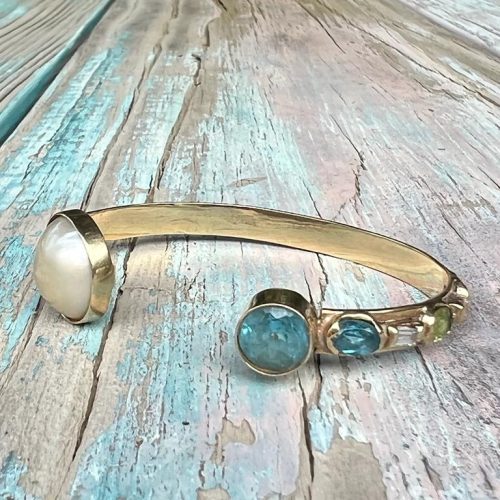 Golden Cuff bracelet with blue and white stones
